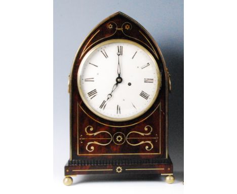 A Regency mahogany and brass inlaid bracket clock, the case of Gothic outline, having convex glass and brass bezel, the unsig