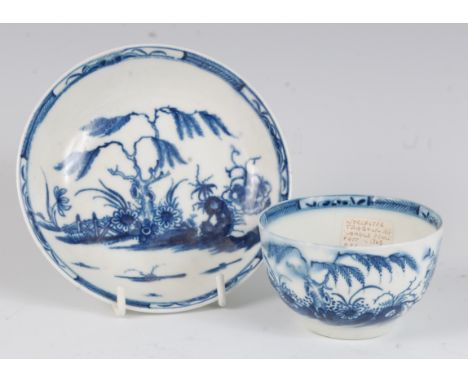A Worcester porcelain tea bowl and saucer, underglaze blue painted in the Candle Fence pattern, circa 1765, saucer dia.12cm (