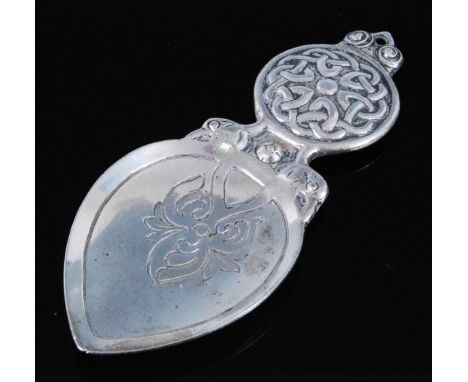 Alexander Ritchie for Iona Celtic Art, a silver caddy spoon, having a spade shaped bowl, the circular handle with raised Celt