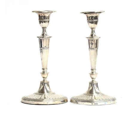 A pair of silver candlesticks by William Hutton &amp; Sons Ltd, London 1908, in the Adam style, having detachable sconce, ova