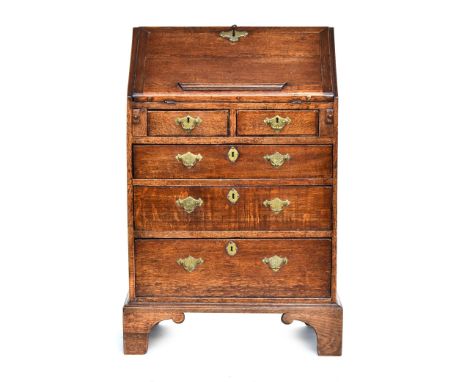 A small George III oak bureau, fall front over two short and three graduating drawers, on bracket feet, with key, 62cm wide, 