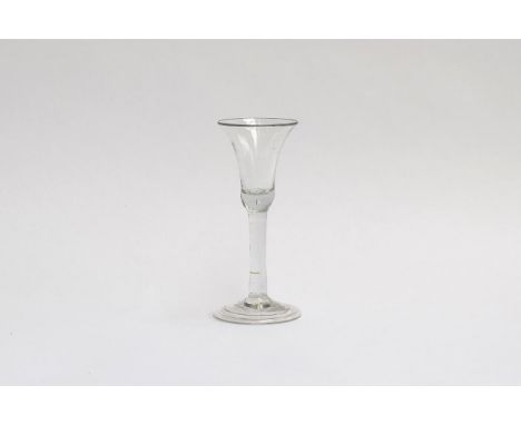 An 18th century ale glass with flared trumpet bowl, on plain stem with folded foot, 15.5 high 