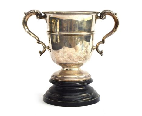 A very large twin handled silver trophy cup by Harrison Brothers &amp; Howson (George Howson), Sheffield, 1908, on ebonised p