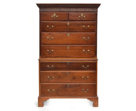 A 19th century mahogany chest on chest, dentil cornice above blind fretwork panel, two short over three graduating drawers fl