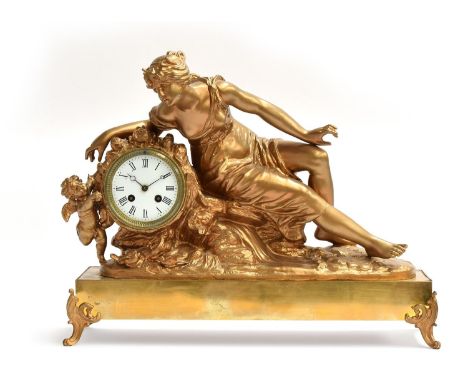 A 19th century French gilt metal ormolu style figural mantel clock, in the form of a reclining lady with cherub and lovebirds