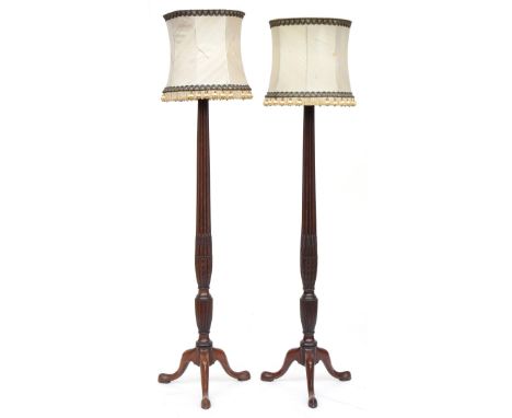 A pair of carved mahogany standard lamps, reeded columns with wheatsheaf carving, on tripod cabriole legs 