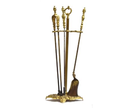 A good set of 19th century gilt metal fire tools, comprising poker, tongs, and shovel, on ornate stand 