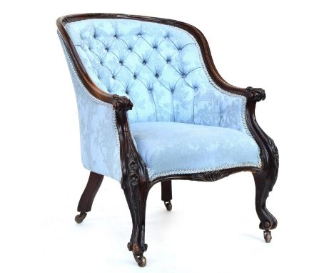 A button back salon chair, curved top rail, with carved supports on scrolling carved legs, with brass casters 