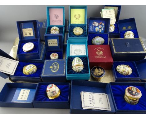 Good collection of boxed mainly Halcyon Days enamel pill boxes and collectable eggs with a quantity of small display stands