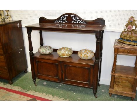 A William IV mahogany buffet, serpentine cresting pierced and carved with a shield and scrolling foliage, turned and reeded b