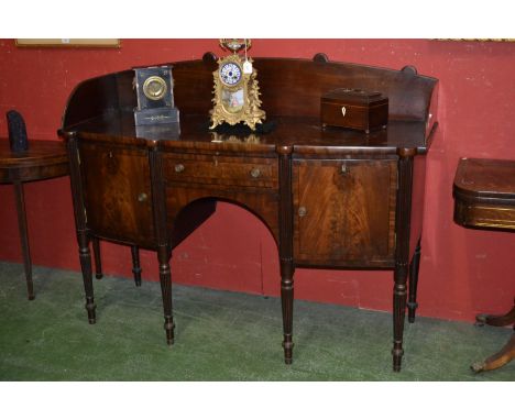 A 19th century mahogany bow-fronted sideboard, shaped three-quarter gallery, above a frieze drawer and a pair of cupboards, d