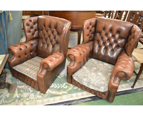 A pair of button upholstered leather wing back office chairs with Liberty fabric Hera and Ianthe seats.