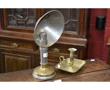 A Victorian brass candle lamp with reflector; a brass chamber stick