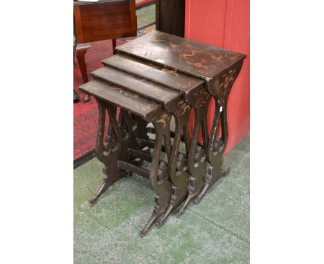 A set of Chinese lacquer quartetto tables, rectangular tops decorated with ferocious dragons, shaped and pierced end supports
