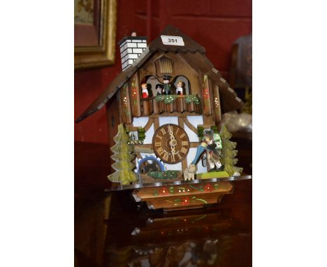 A German novelty cuckoo clock, Swiss musical movement, weights and pendulum