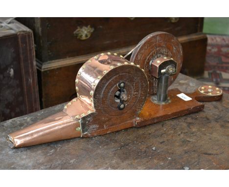 A pair of copper bellows, manual winder, mounted on an oak frame