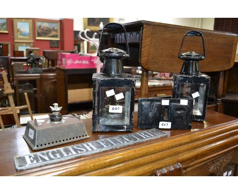 Two railway lamps; a Midland Railway stop tap cover; an aluminium English Electric sign; another lamp.