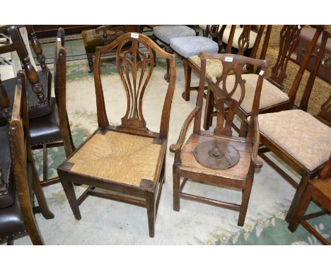 A 19th century ash and elm dining chair with rushed seating; a 19th century elm child's open arm commode chair