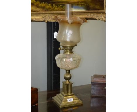 An early 20th century brass oil lamp, clear cut glass reservoir, acid etched shade, Duplex FS & Co twin burner, stepped squar