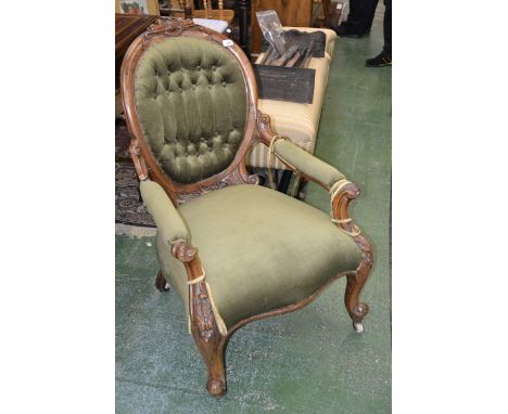 A Victorian walnut spoon back armchair, outswept arms, stuffed over upholstery, carved throughout with acanthus scrolls, cabr
