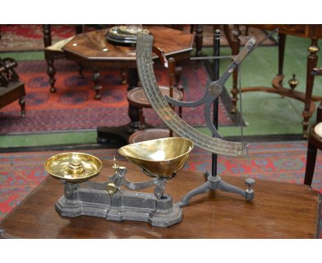 A brass and cast iron balance, curved brass scale, by H E Messmer, London; a set of cast iron and brass kitchen balance scale