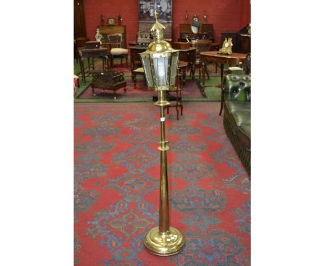 An ornate brass standard lamp in the style of a street light
