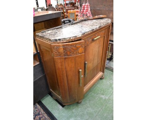 An Art Deco side cabinet, variegated marble top, single carved front  drawer over fluted panel door, flanked by radiused  cup