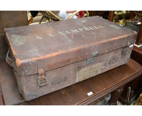 An Early 20th century leather travelling trunk, fabric lining, Named A A Campbell, travelling labels for Penang, Singapore, K