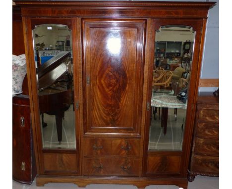 A mahogany inlaid combination wardrobe of 2 mirror doors, fitted central unit with single door compartment, 2 drawers under, 