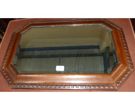 A 1930's bevelled edge wall mirror with canted frame