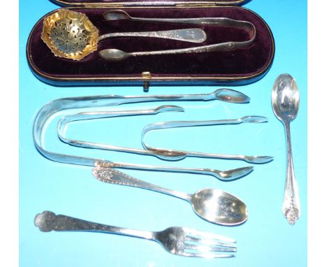 A cased sugar sifter, spoon and tongs, Birmingham 1891; 3 pairs of silver sugar tongs; 2 teaspoons; a fork; 5 oz. gross