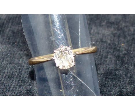 A yellow metal dress ring set with a single old cut diamond, stamped '18CT'