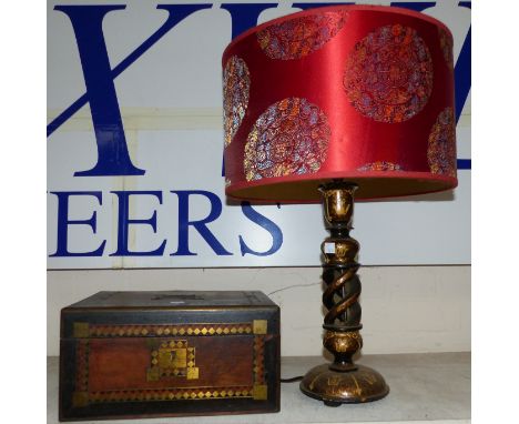 A black lacquer oriental lamp with gilt decoration and red shade and a lap desk with brass inlay