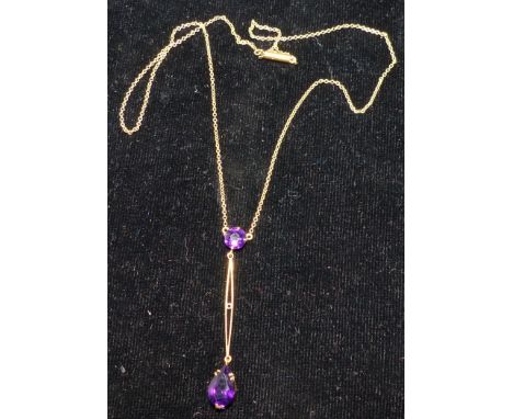 A pendant set with 2 amethyst coloured stones, stamped '15CT', on fine chain; 3 simulated pearl necklaces