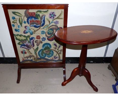A mahogany firescreen with central woven flower scene; a mahogany occasional table