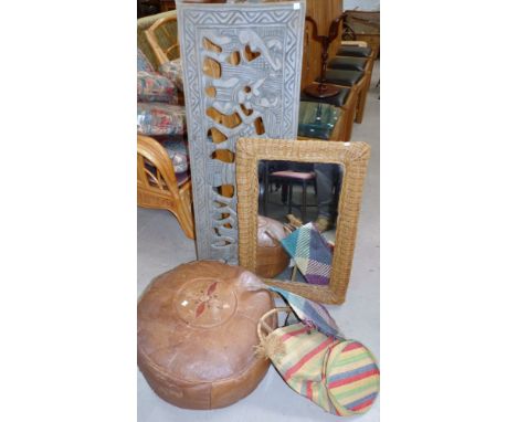 A Nigerian carved and pierced wood panel, signed, 46"; a leather pouffe and items of basketry