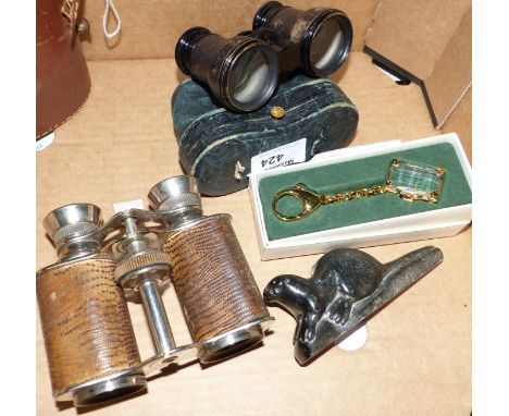 A pair of snakeskin opera glasses, stamped Lumière Paris; a pair of cased opera glasses; an Inuit soapstone seat; a Swarovski