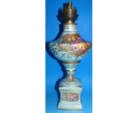 A late 19th / early 20th century French porcelain oil lamp base, the reserve panels decorated with roses and other flowers in