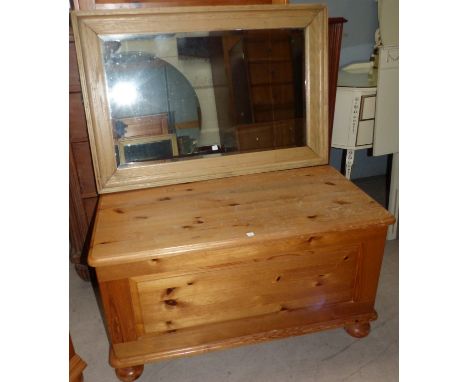 A pine framed rectangular wall mirror; a pine blanket box