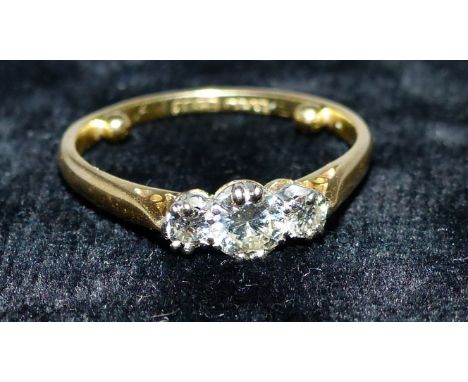 A 3 stone brilliant cut diamond ring, stamped '18CT' & 'PLAT'