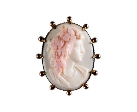 A shell cameo brooch, second half of the 19th centuryOval, carved to depict a Bacchante in profile, facing right, wearing a g