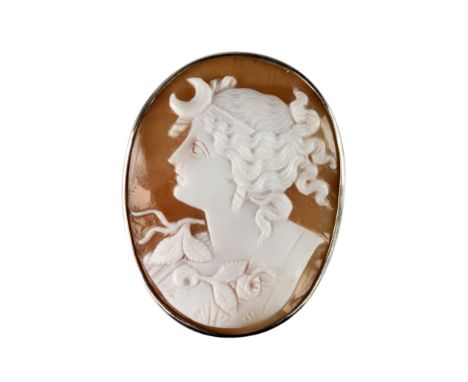 A shell cameo brooch, second half of the 19th centuryOval, carved to depict Diana in profile, facing left and wearing a cresc