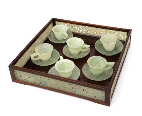  Six jade cup-and-saucers, China, 20th century. On a tray framed with jade strips. Serveerblad 27,5 x 27,5 cm. 