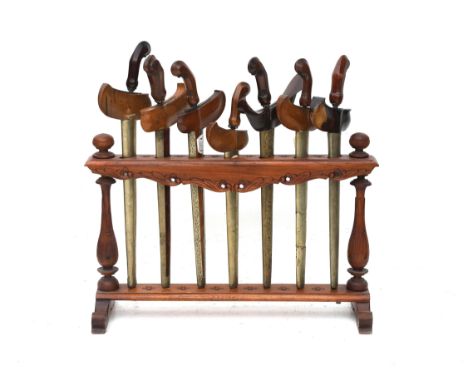  An Indonesian Ploncon or standard for Krissen with 7 Krissen from the 19th or 20th century. The ploncon is decorated with cu