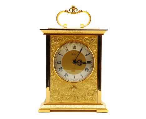An Imhof gilt metal mantel clock,with scrolling decoration around a metal dial, and a key wind movement,20.5cm wide12.5cm dee