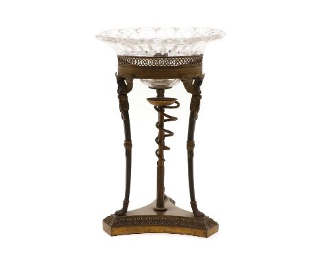 A French Empire candlestick,19th century, formerly part of a table garniture, the cut glass drip tray, leading to a pierced g