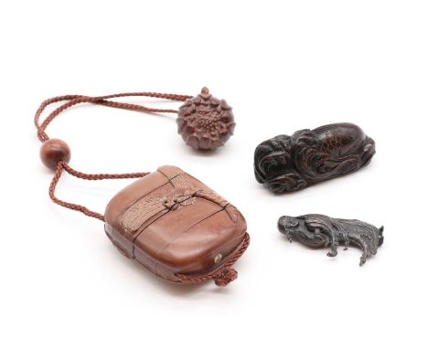 A Japanese wood netsuke,20th century, carved with a carp among waves, signed, 6.5cm long, together with a three-tier wood inr