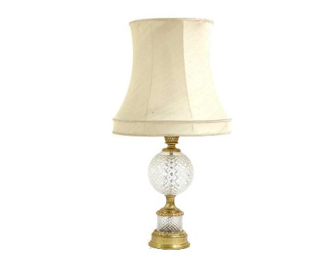 A large Waterford crystal glass table lamp,the globular diamond cut body, enclosed by gilt metal mounts, with pale shade,57.5