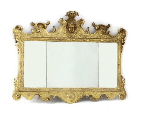 A Georgian style overmantel mirror, with a carved and gilt scrolled frame, centred with a cherub head, with three mirror plat