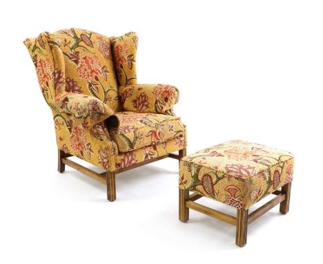 A George III style wing armchair,of recent manufacture, labelled Omega, with foliate upholstery,90cm wide105cm deep108cm high